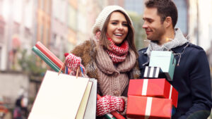 Happy couple shopping for Christmas in the city
